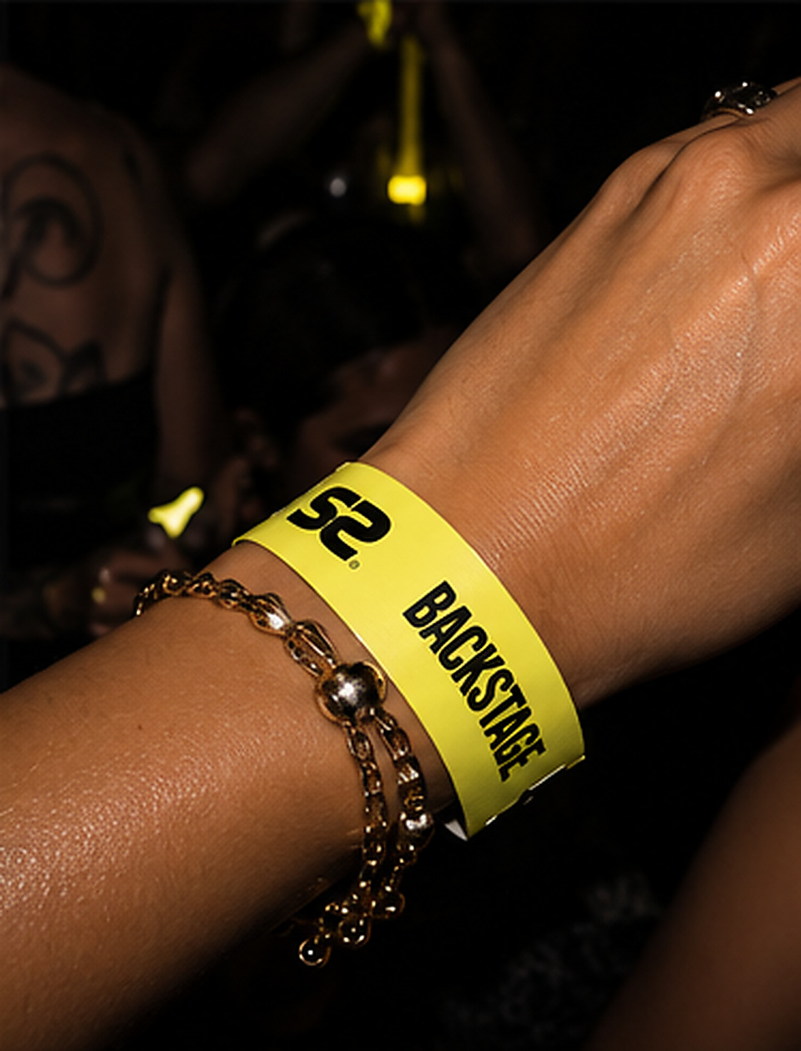 Yellow Secret Sessions backstage wristband worn at an event