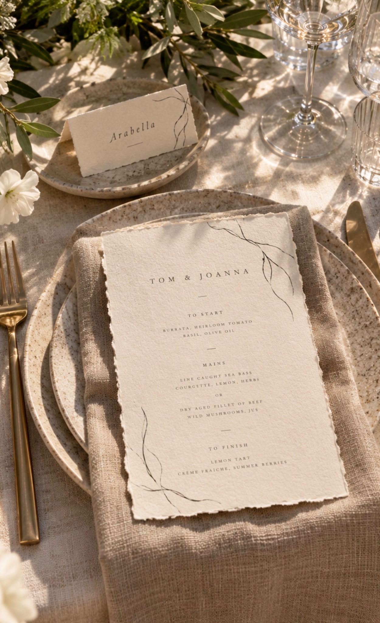 Tom and Joanna menu on a ceramic plate beside an Arabella place card